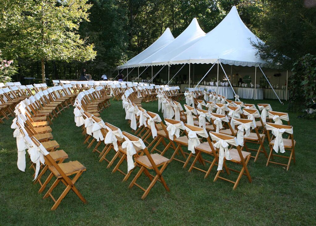 Wedding chairs arranged under outdoor tent