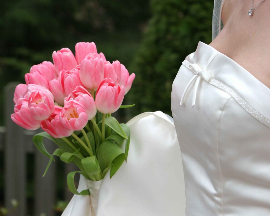 Bride holding pink tulip wedding bouquet